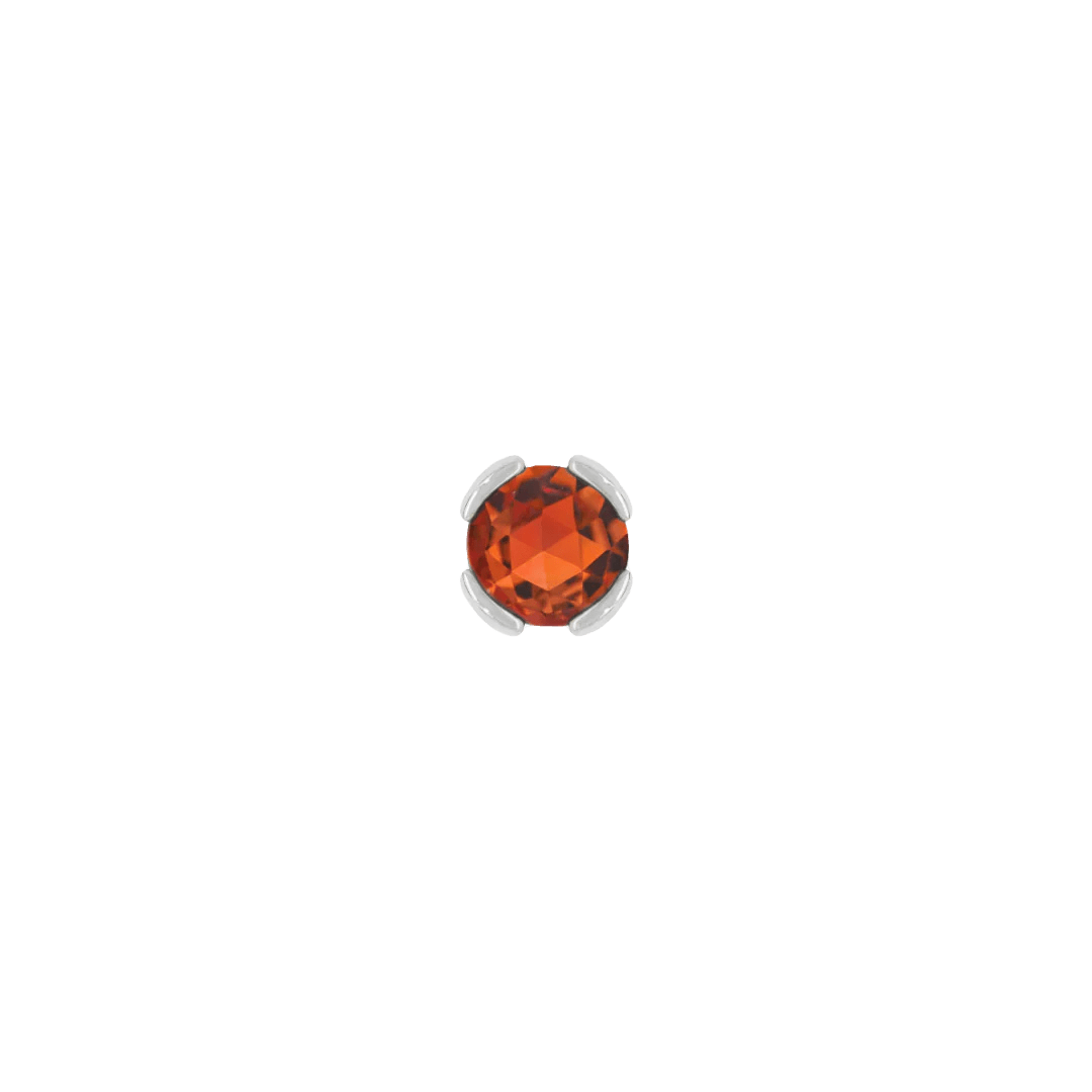 Close-up of fiery gemstone stud in solid gold setting