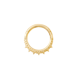 Close-up of ornate spiked Brooklyn clicker in yellow gold