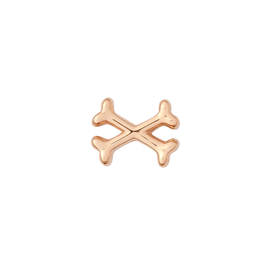 Edgy gold piercing charm in crossbones design