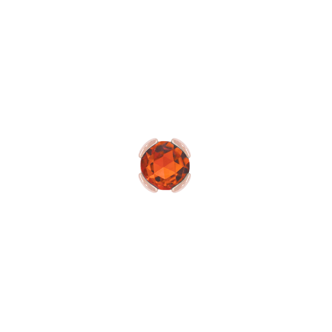Macro image of bright orange garnet in minimalist bezel