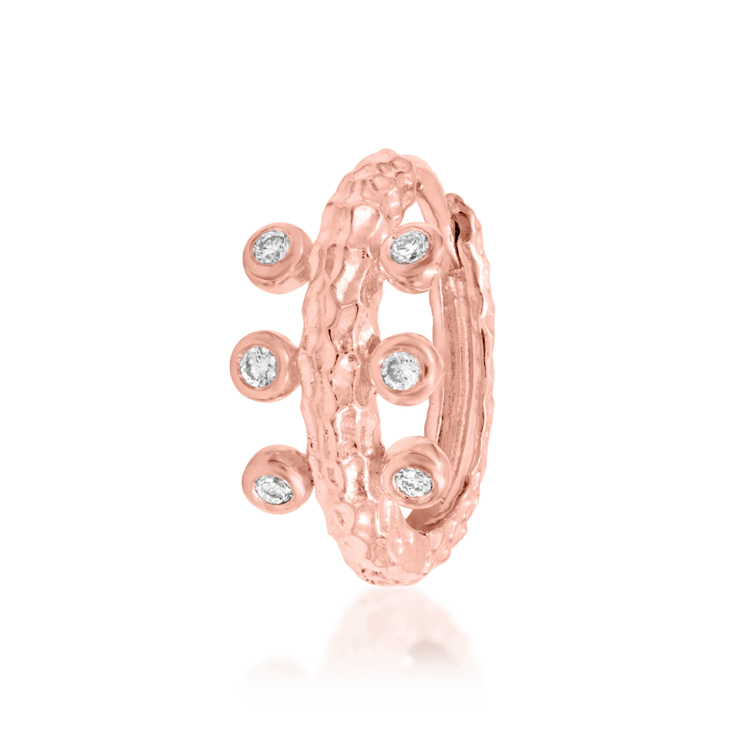 Close-up of Rora clicker in rose gold – six small CZ stones across the band