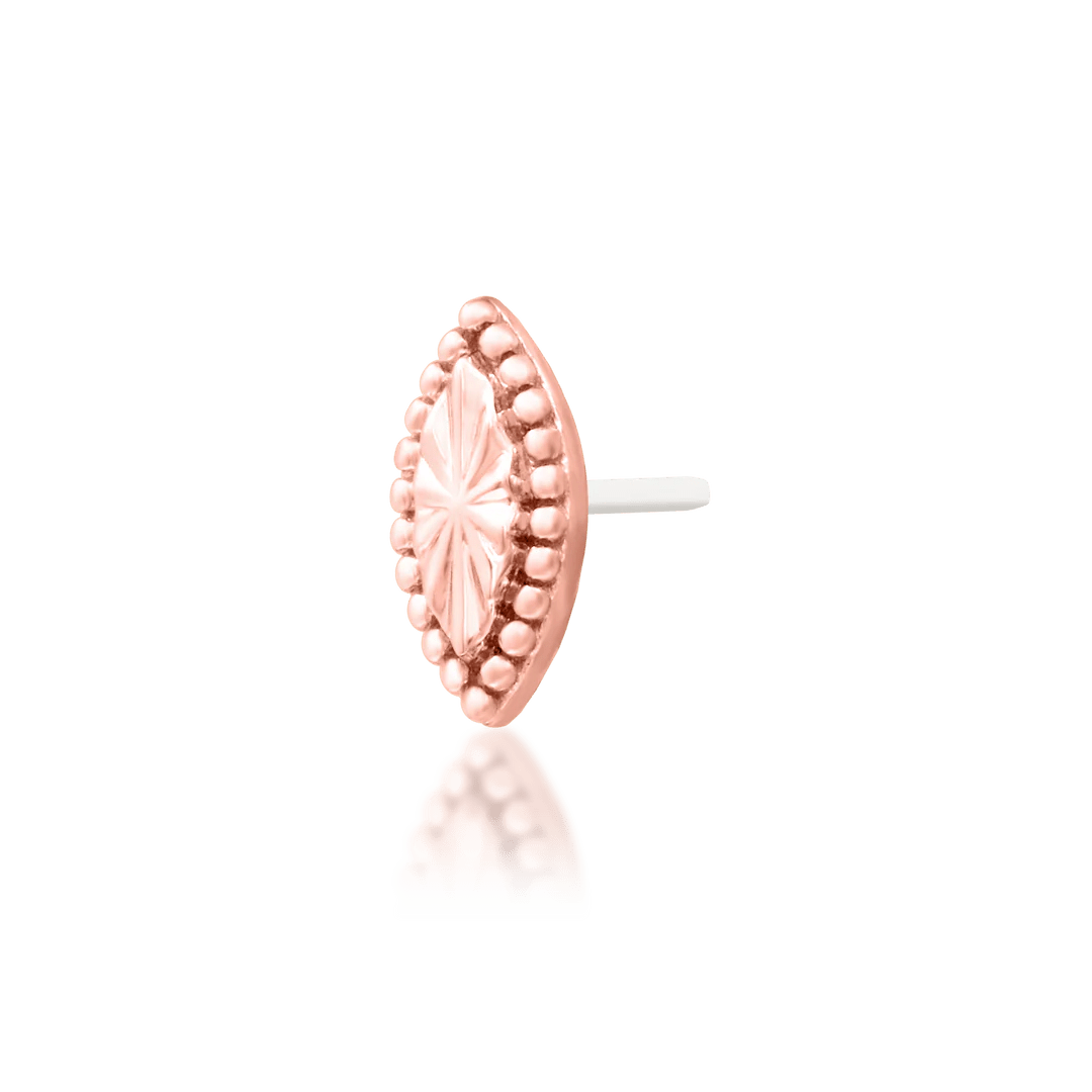 Styled photo of Novie worn in tragus piercing – subtle gold accent