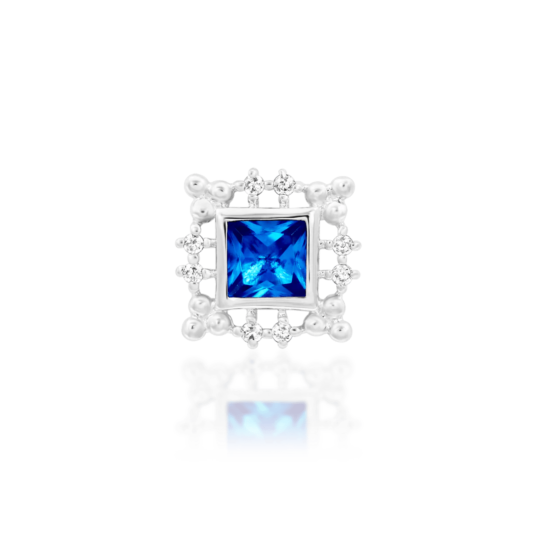 Blue Topaz Piercing Jewelry on White Background – Close Focus