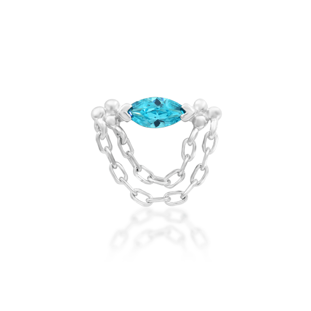Gold piercing jewelry with dangling chain and blue gemstone