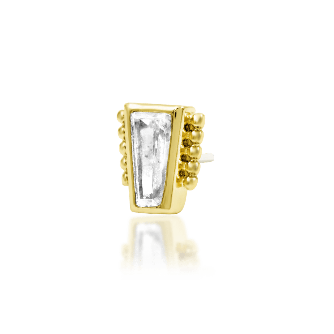 Close-up of baguette CZ framed in gold beading – elegant jewelry detail
