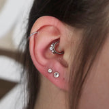 Close-up of a daith and helix piercing performed by Alina Kalina at Piercing Zone.