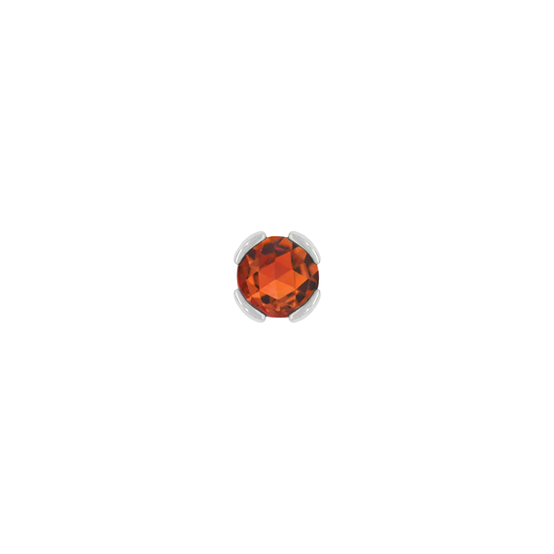 Close-up of fiery gemstone stud in solid gold setting