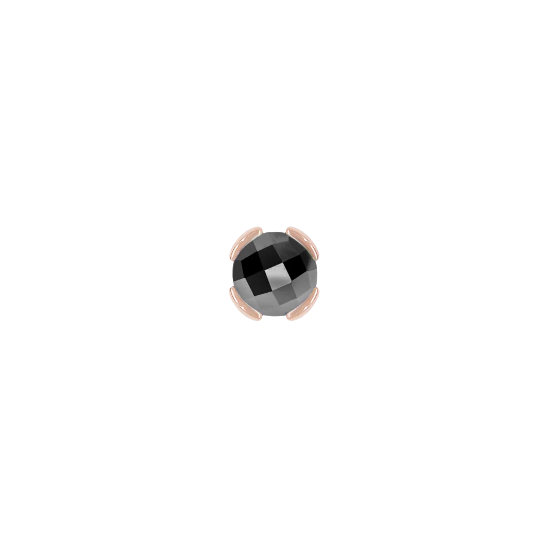 Close-up of minimalist 14k gold stud with 3mm black spinel gemstone