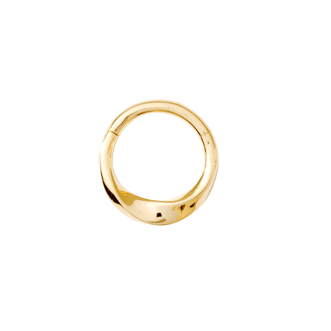 Close-up of sculpted gold septum clicker with polished finish
