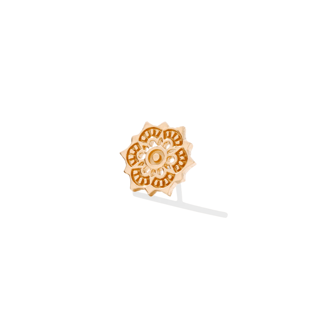 Flat lay of lotus piercing pin with delicate cutout details