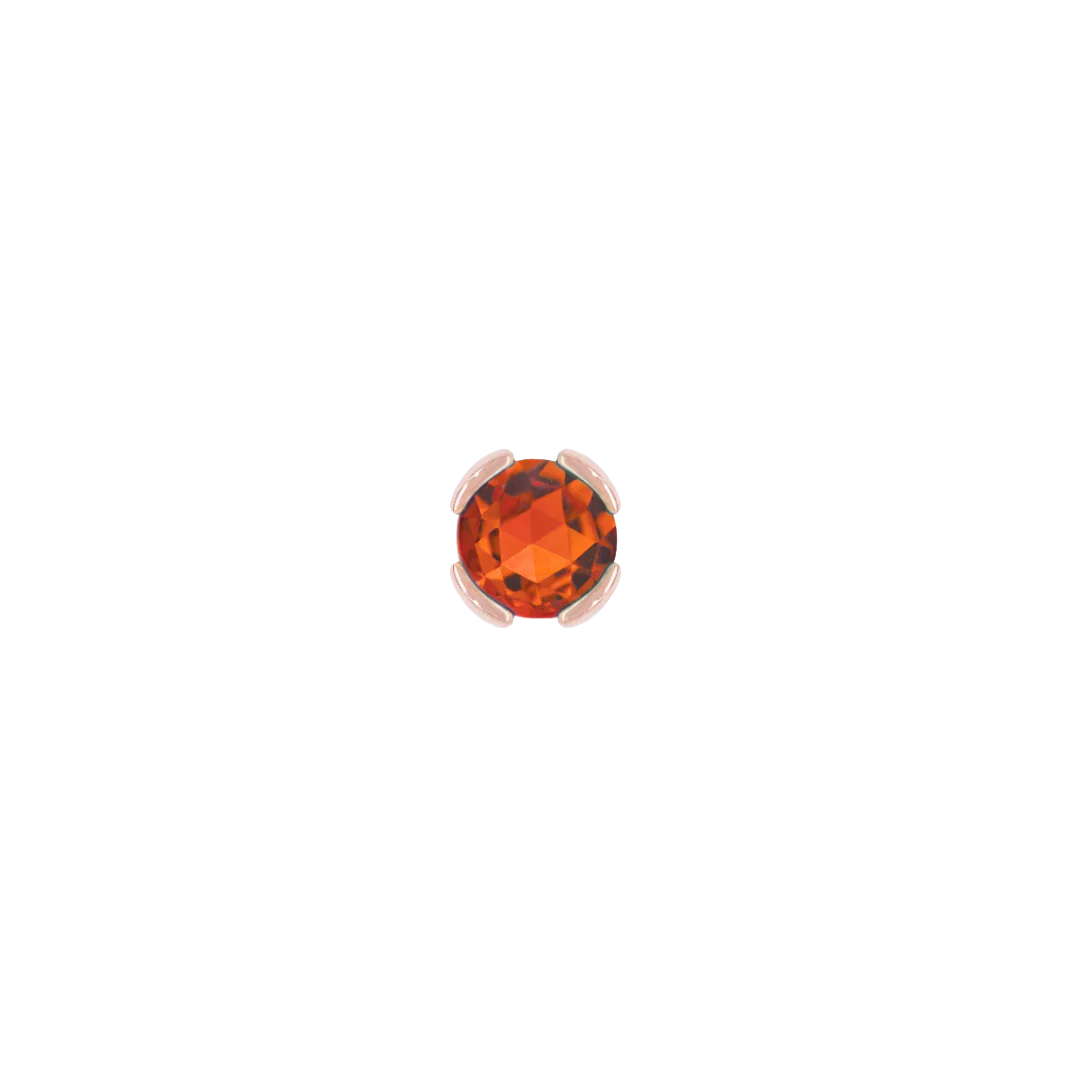 Macro image of bright orange garnet in minimalist bezel