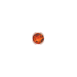 Macro image of bright orange garnet in minimalist bezel