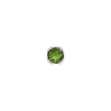 Macro shot of rose-cut green tourmaline set in solid gold bezel