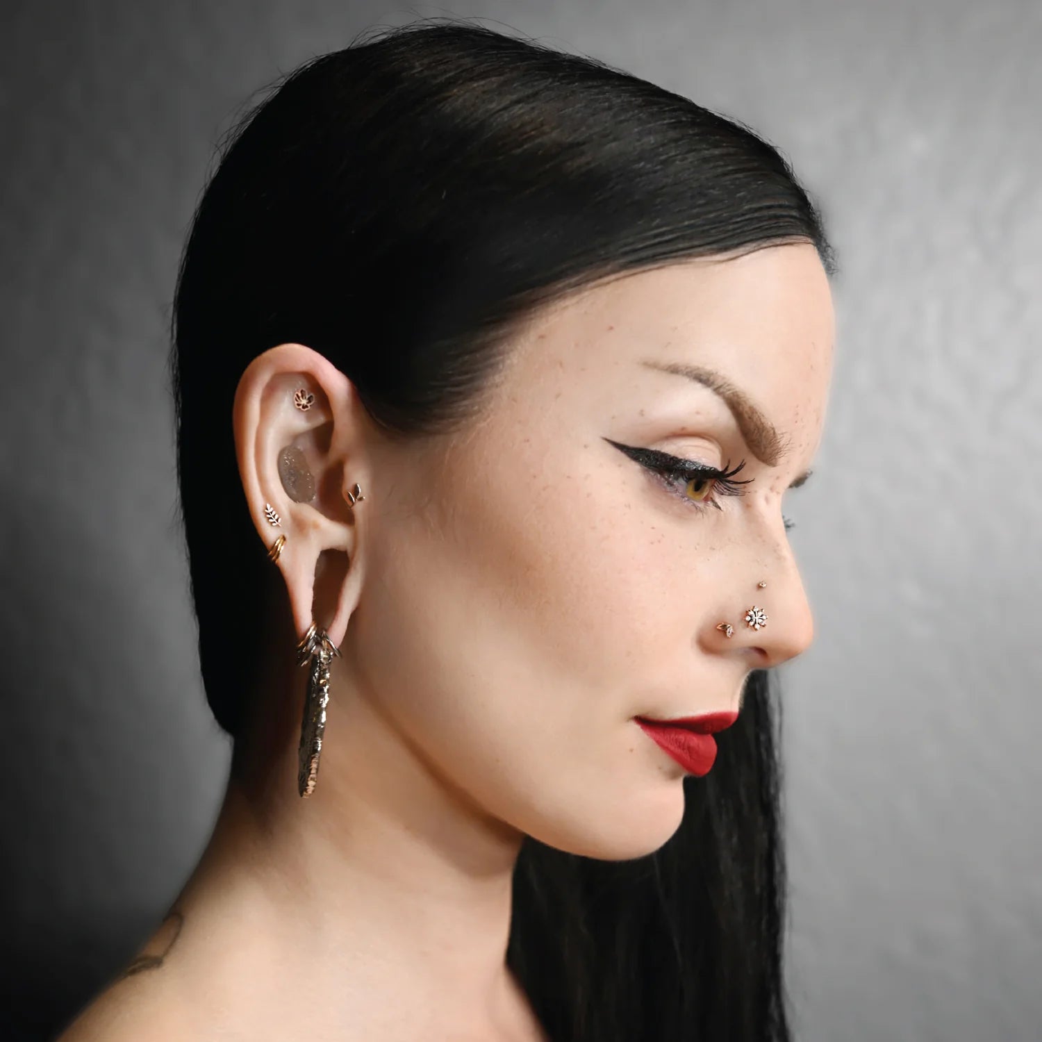 Low-profile piercing jewelry with marquise and round diamonds