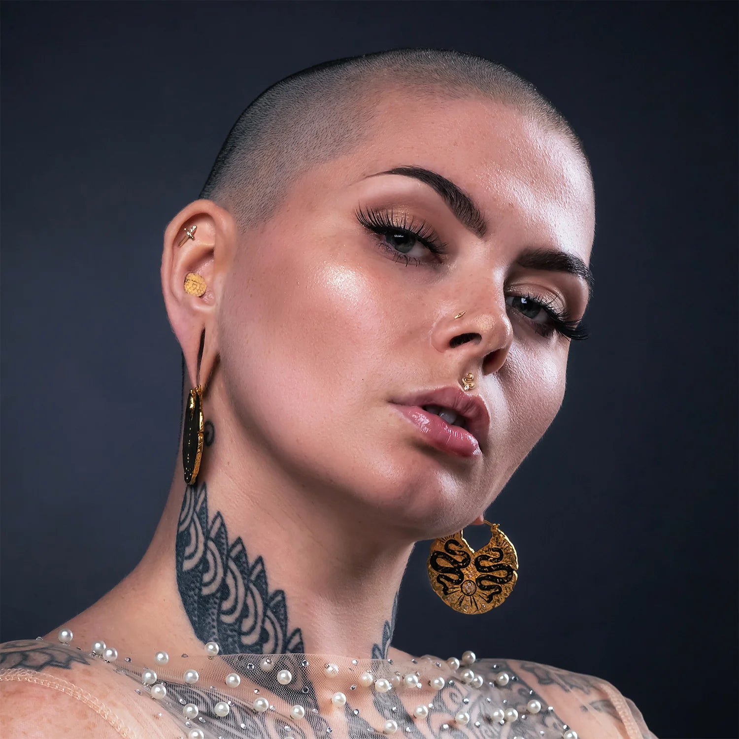 Gold dagger piercing jewelry with crystal-inlaid handle