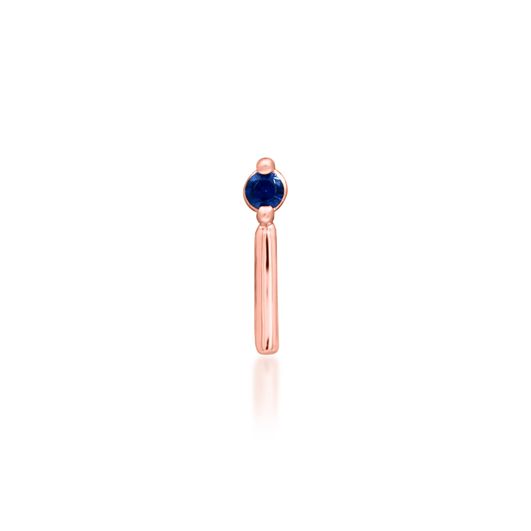 Vast piercing end in rose gold – elegant deep blue sapphire profile