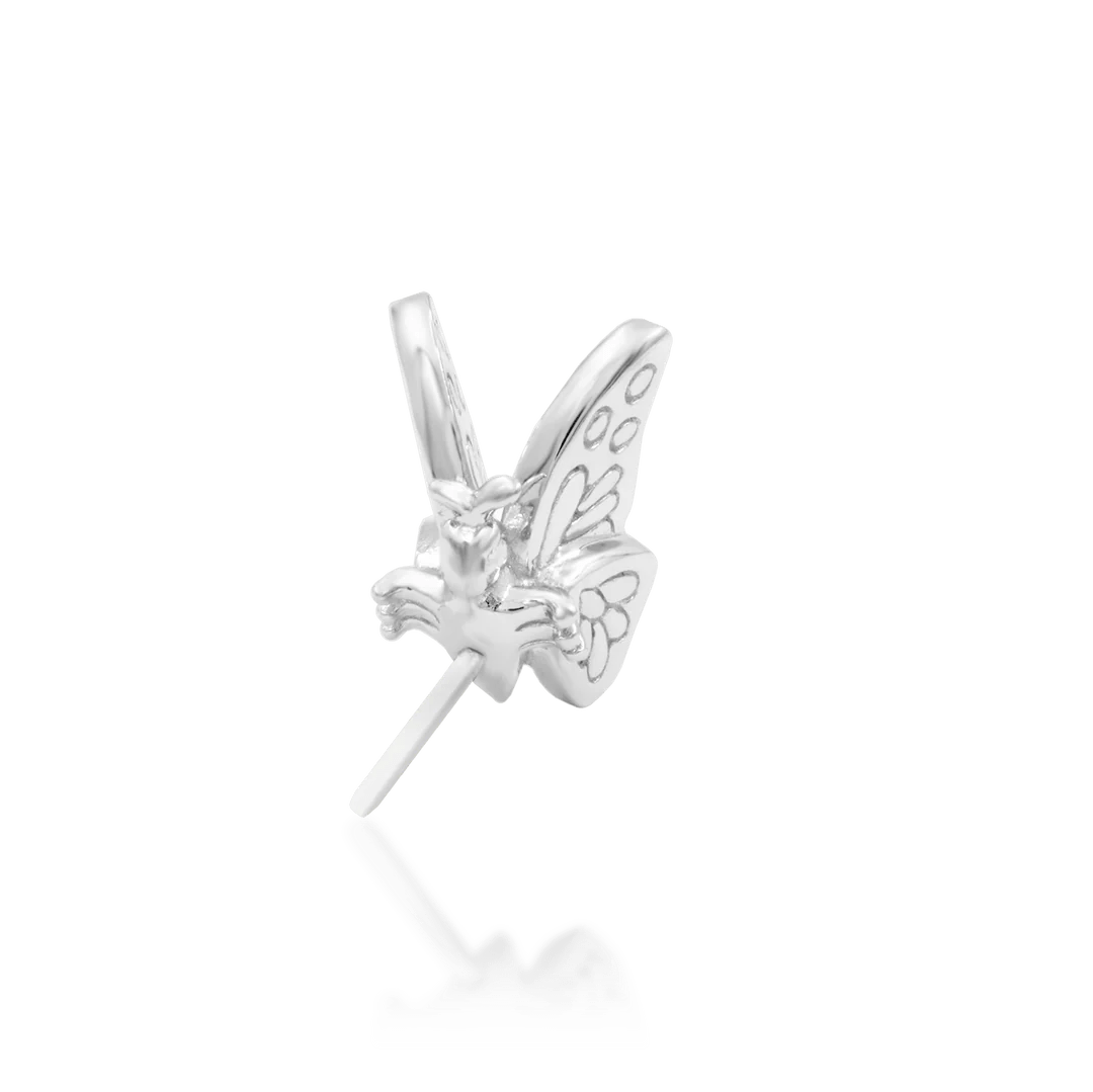 Delicate butterfly jewelry piece in white gold – flat lay perspective